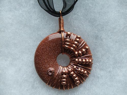 Wire wrapped donut pendant necklaces by salcerro, via Flickr .