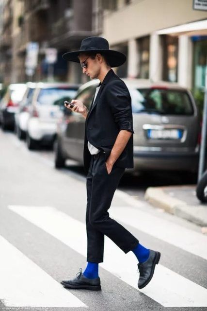 With white shirt, black blazer, blue socks, shoes and wide brim .