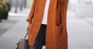 Fall/winter orange coat with blue dark jeans, steet style outfit .