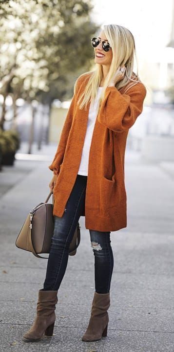 Fall/winter orange coat with blue dark jeans, steet style outfit .