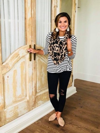 Black and white striped top paired with distressed jeans, mules .