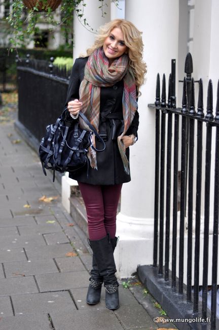 Black trench coat, purple print scarf, black shirt, purple jeans .