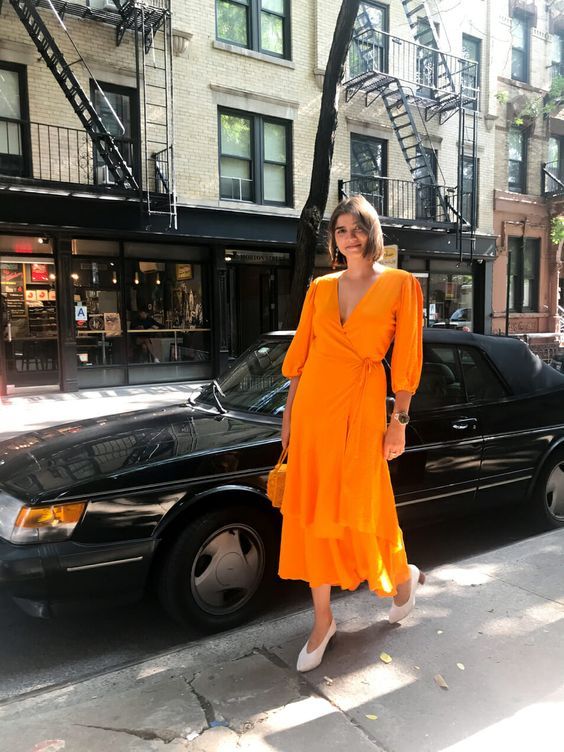 a bright orange midi wrap dress with long sleeves, trendy white .