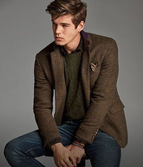 Man models tweed jacket, green cable-knit sweater & jean #brown .
