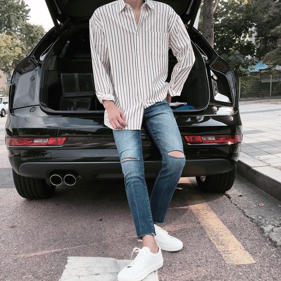 white Vans sneakers, distressed jeans, a loose striped shirt for a .